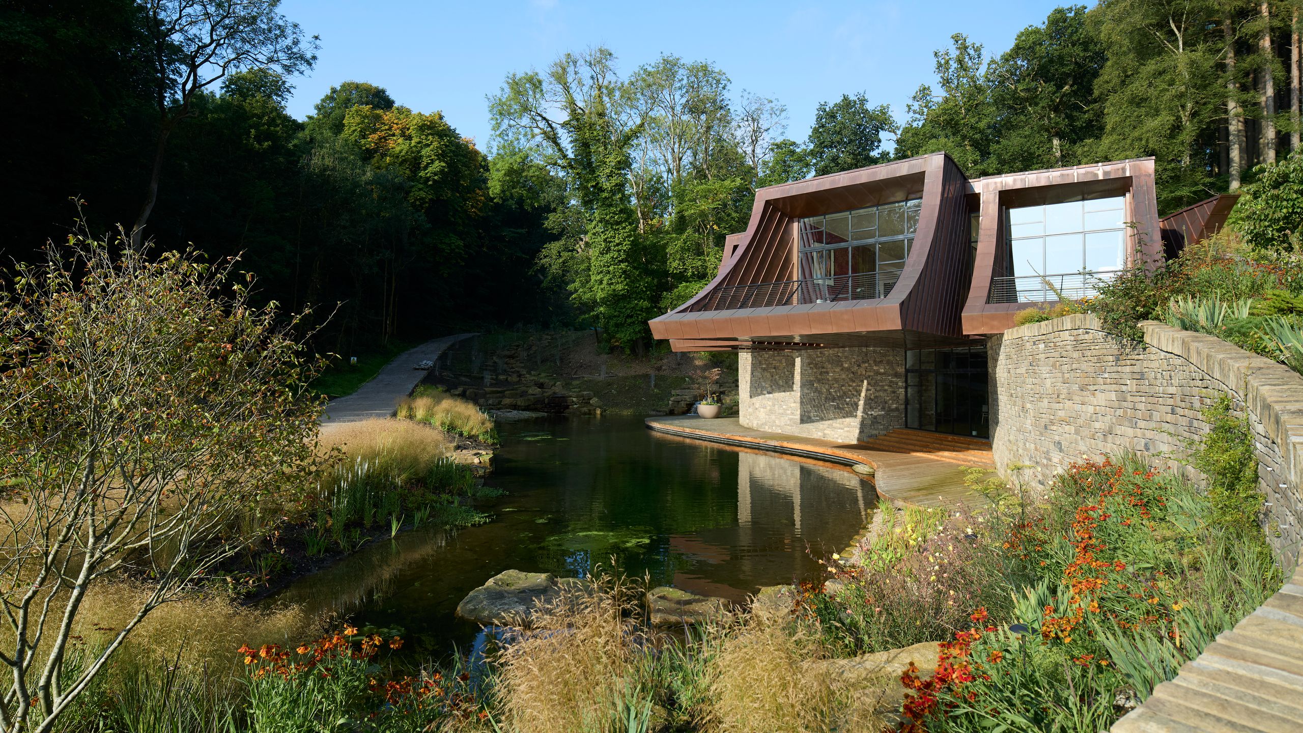 Image may contain: Nature, Outdoors, Scenery, Pond, Water, Architecture, Building, Cottage, House, Housing, Grass, and Plant